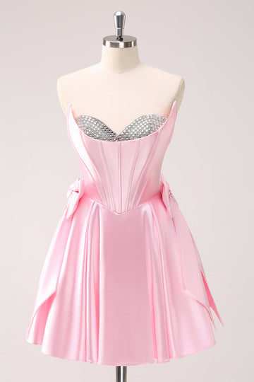 Vestido de fiesta corto con escote en A sin tirantes y corsé en color rosa con lazos
